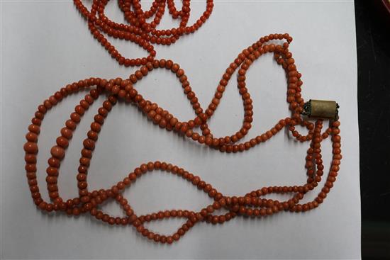 A group of assorted coral jewellery, including necklaces.